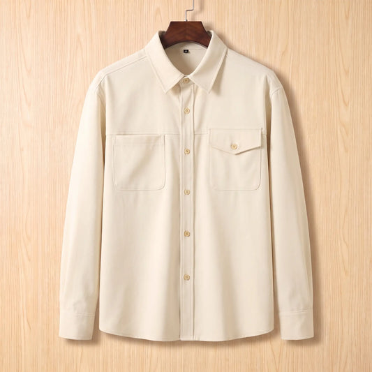 Boxy Cotton Overshirt in white, a loose fit utility overshirt with asymmetric chest pockets on a wooden hanger