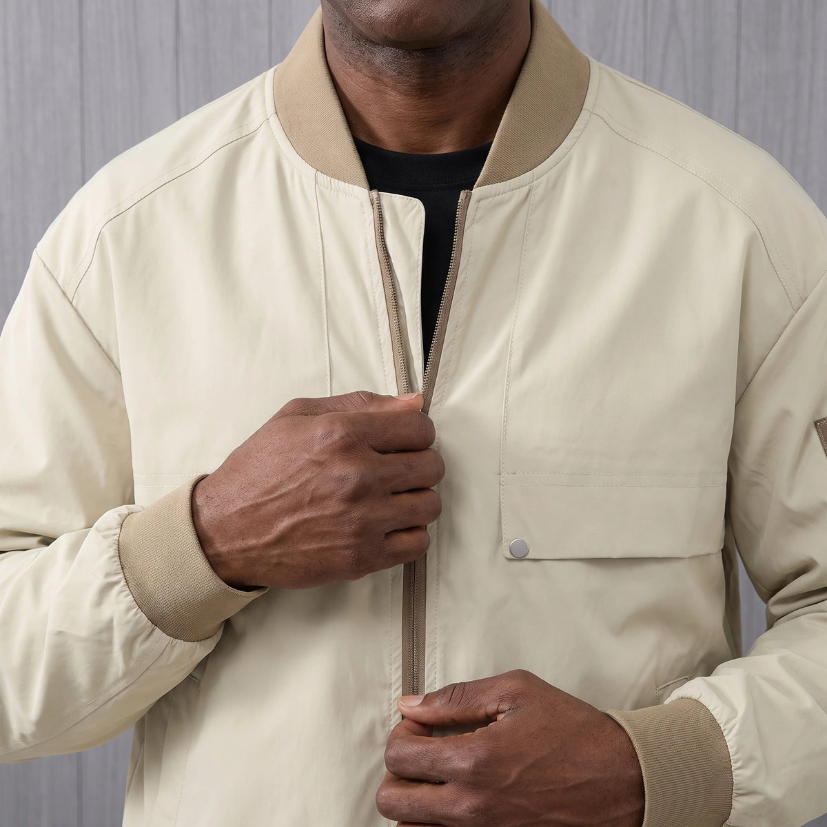 Man zipping up the bomber jacket