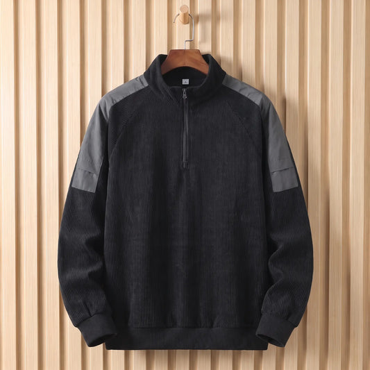 Men's black corduroy quarter-zip sweatshirt with grey shoulder panels on a wooden hanger