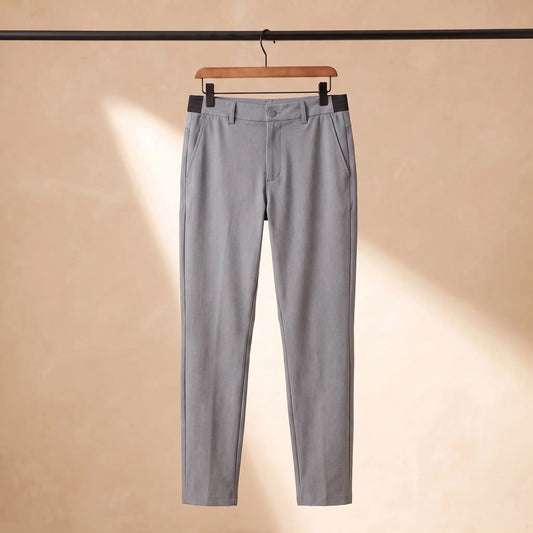 Easy waist slim trousers in grey with elastic back waistband, hanging on a wooden hanger