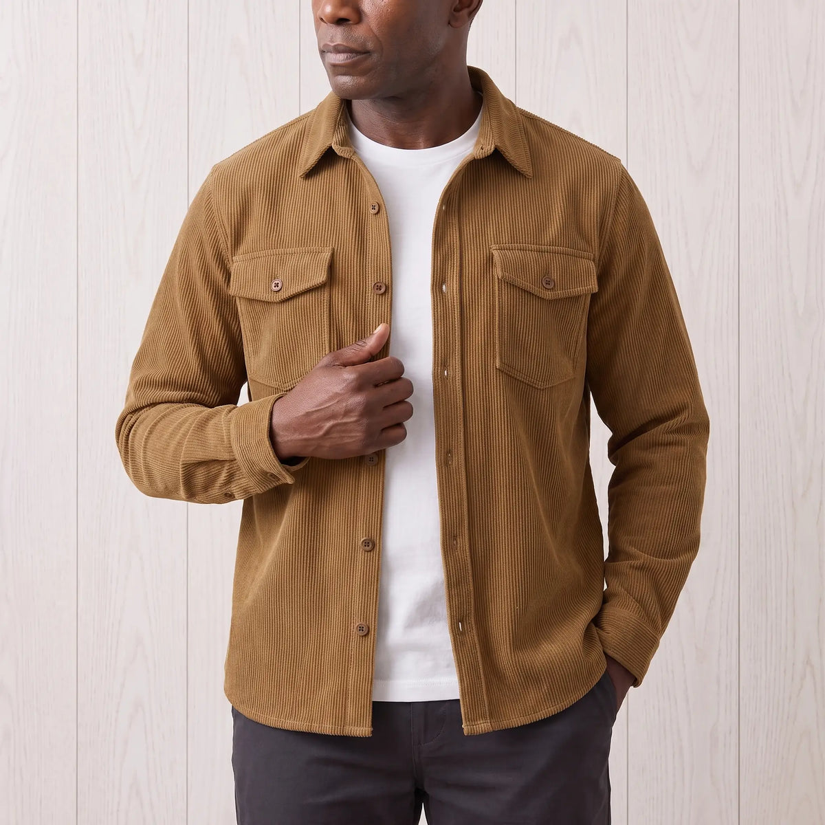 Man about to button the brown Fine Cord Overshirt over a white tee, men's corduroy shirt jacket