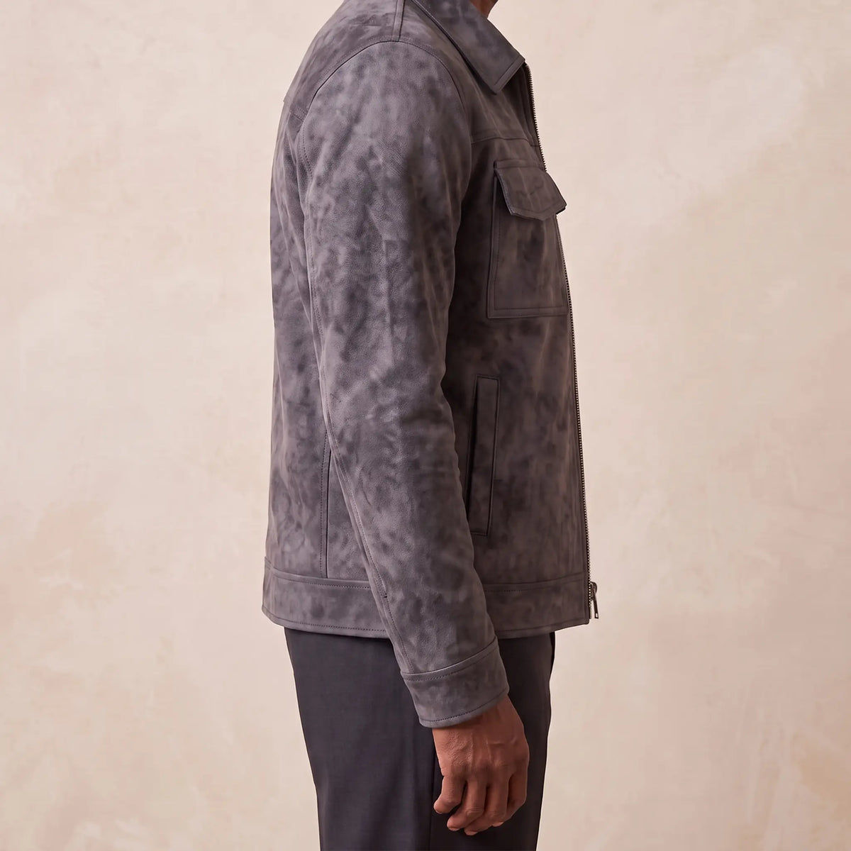 Side profile of the frosted suede jacket showing its shape and drape