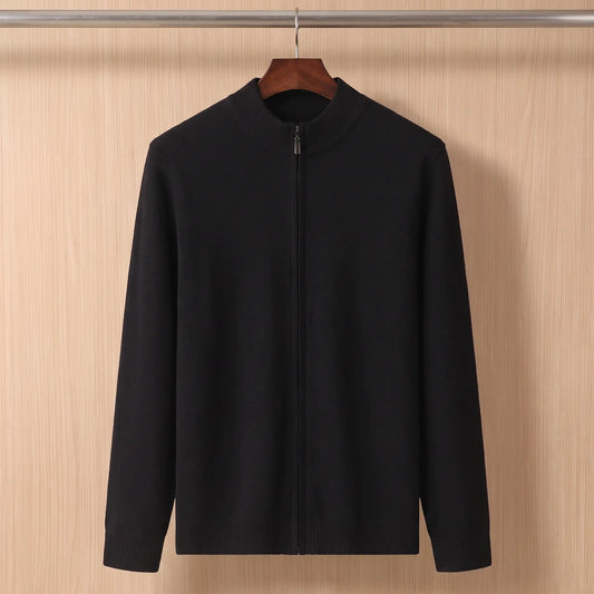 Black funnel neck zip sweater on a wooden hanger against a chestnut plank wall