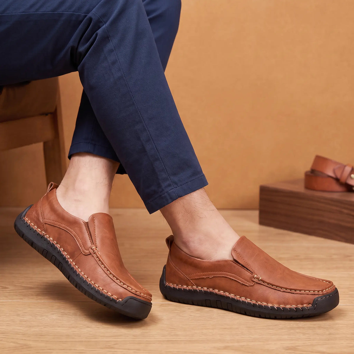 Hand Stitched Loafers in Brown worn as a pair with navy blue chinos