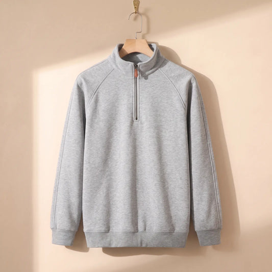 Heather quarter-zip top in light grey on a wooden hanger