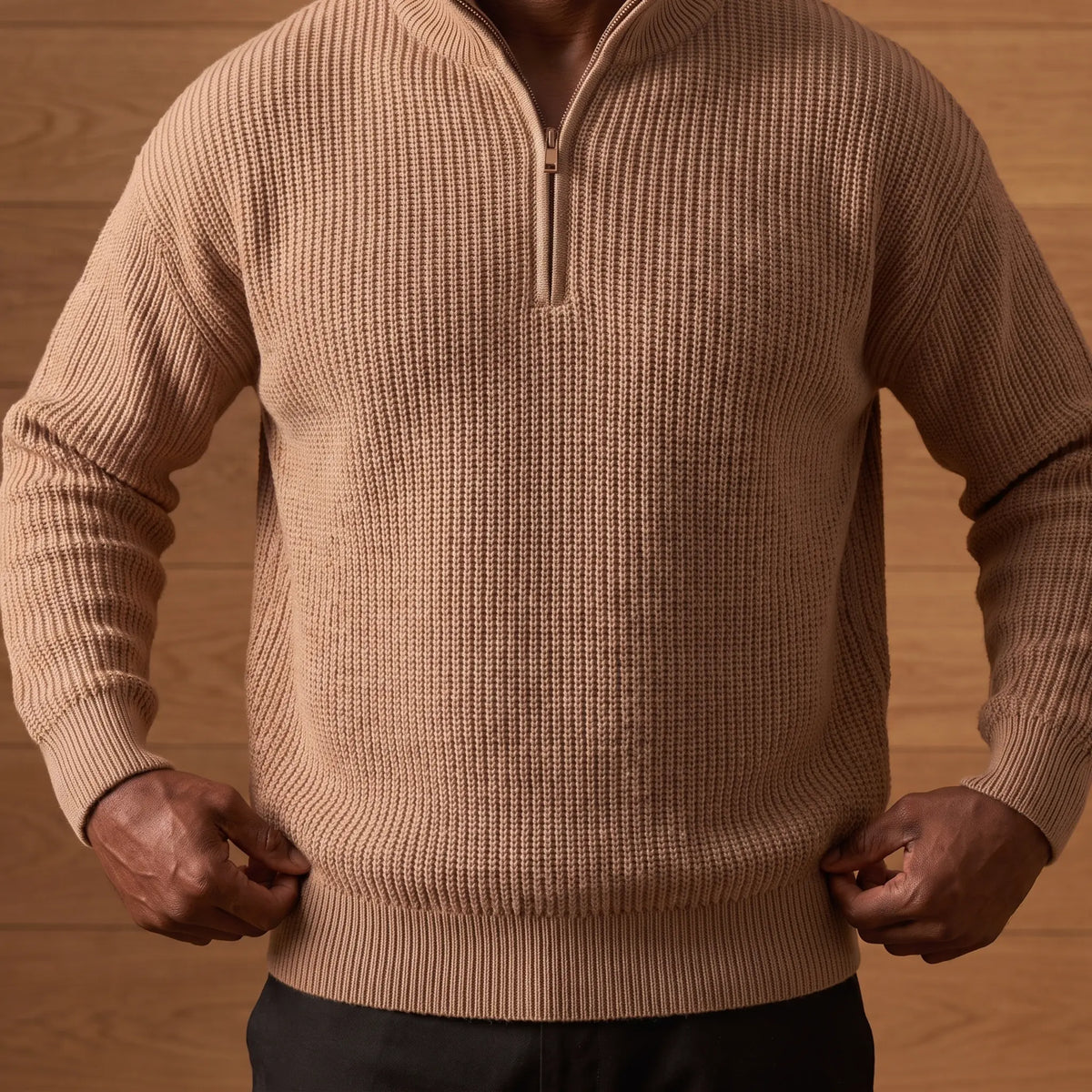 Man settling the hem of the khaki heavy rib knit quarter zip sweater