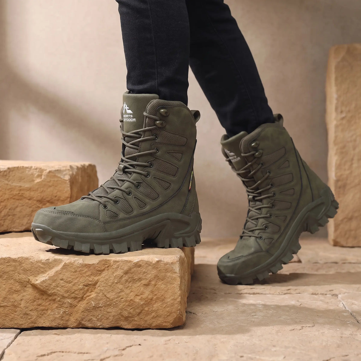 Man wearing green high lace leather boots stepping onto a stone step