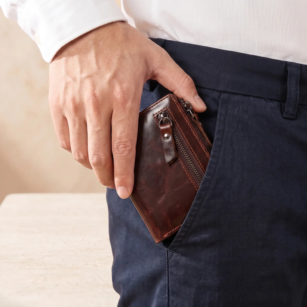 Leather Coin Wallet in Brown, slipped into a trouser pocket