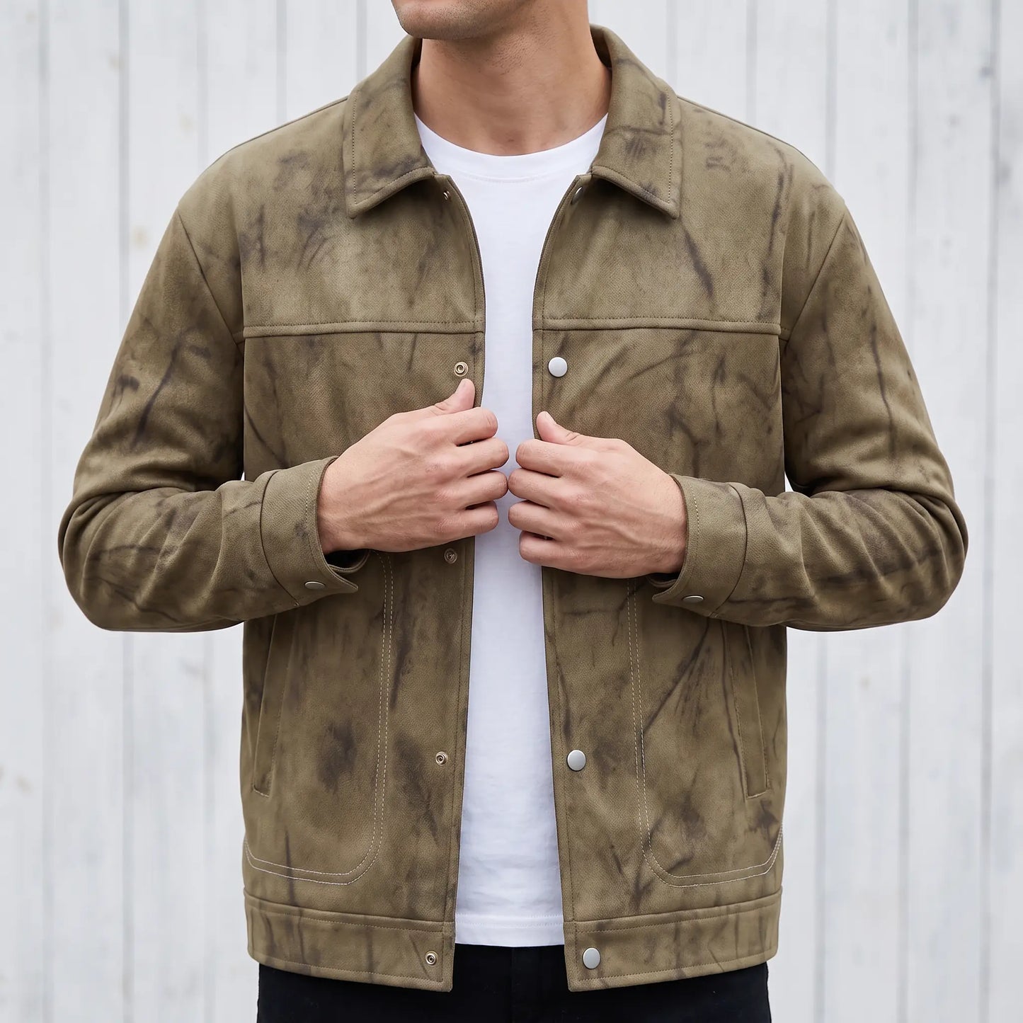 Man wearing the khaki marbled dye trucker jacket and snapping the front closed