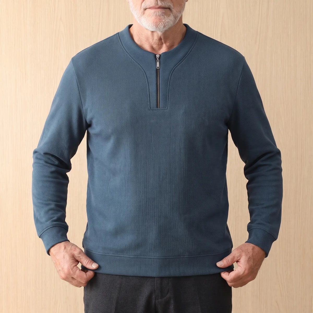Man settling the blue Notch Neck Pullover at the hem, men's textured half-zip sweater