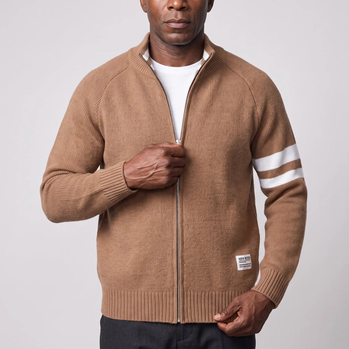 Man zipping up the brown Raglan Zip Cardigan over a white tee, men's knit stand collar cardigan