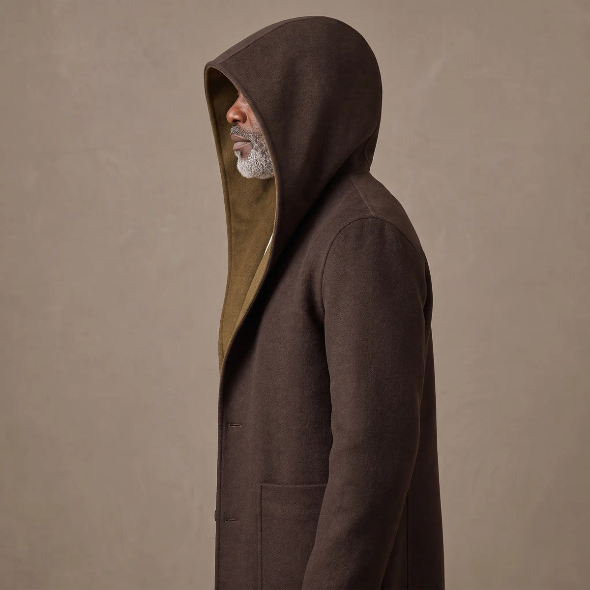 Man in side profile wearing the SHAWL HOOD COAT with the hood pulled up