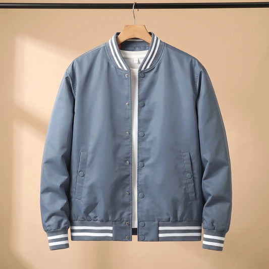 Men's blue snap-front baseball bomber jacket with white-striped rib collar, cuffs and hem on a wooden hanger
