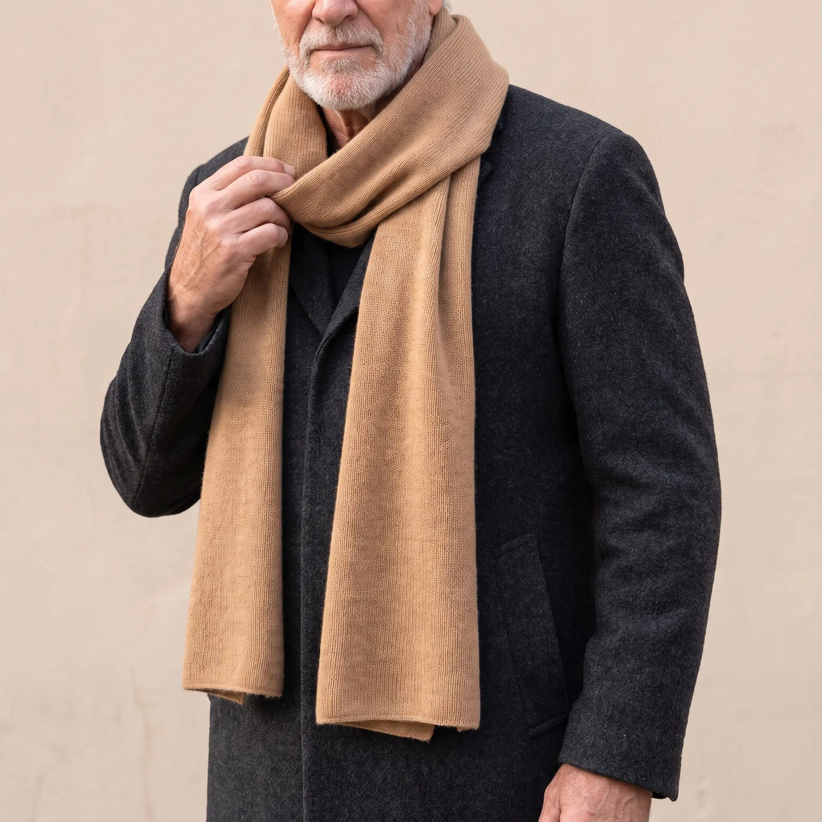 Soft Knit Scarf in Camel worn over a charcoal overcoat