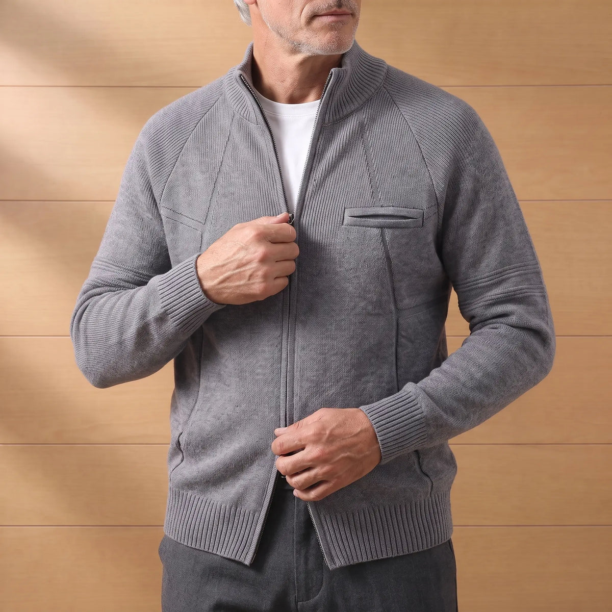 Man zipping up the STAND COLLAR CARDIGAN in dark gray over a white tee