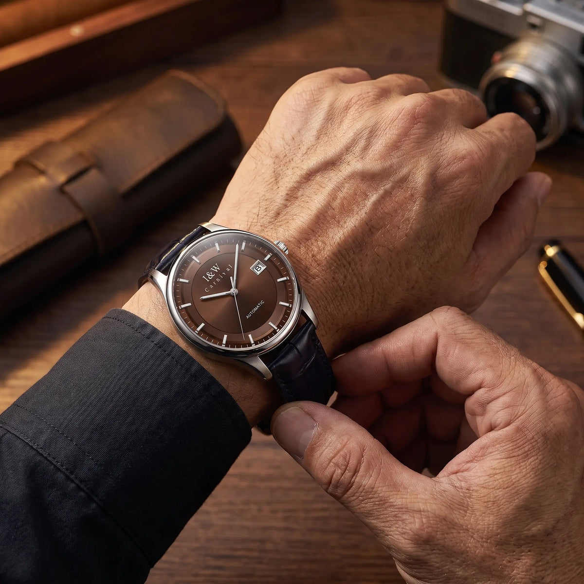 Man fastening the brown dial two tone automatic watch onto his wrist
