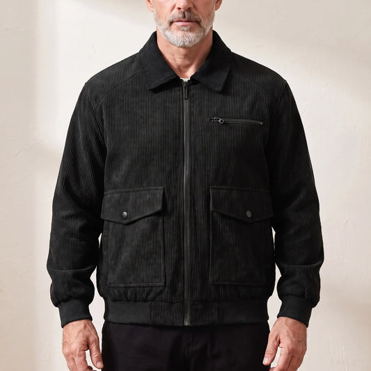 Men's black corduroy zip jacket with shirt collar and snap-flap pockets, worn zipped