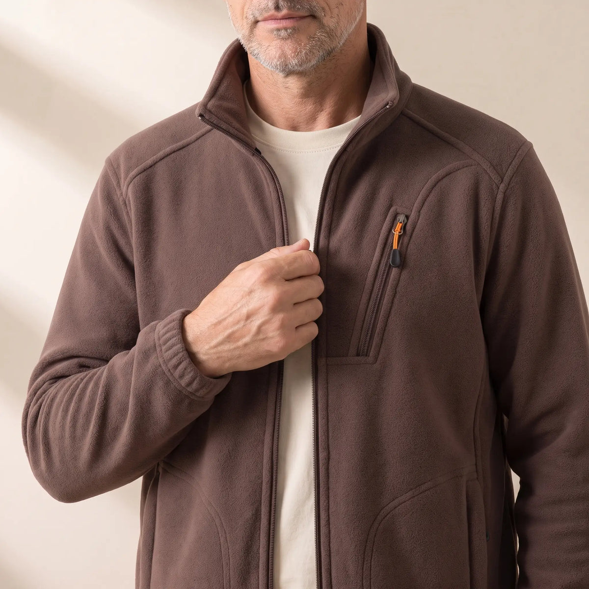 Man zipping up the WARM LINED FLEECE in brown