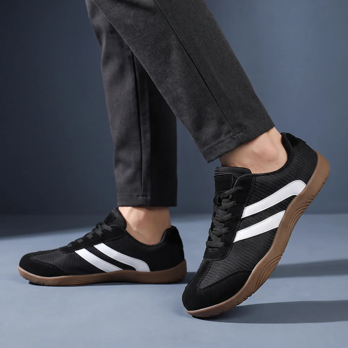 Man wearing black wide toe barefoot sneakers with charcoal tapered trousers