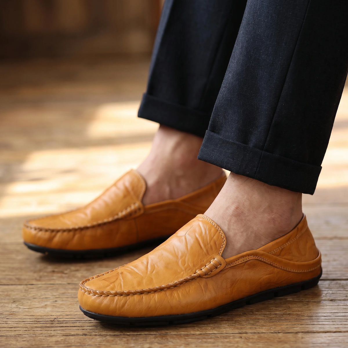 Man wearing tan loafers with dark trousers