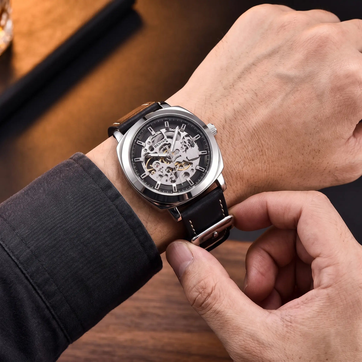 Man fastening the Exposed Gear Watch onto his wrist
