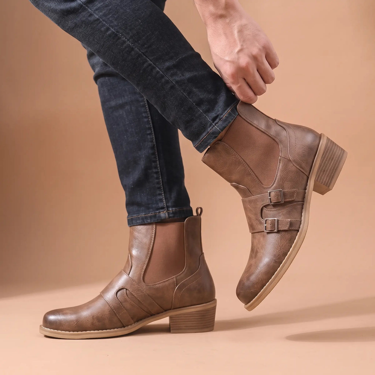Man wearing the Grained Finish Boots, adjusting the buckle strap mid step
