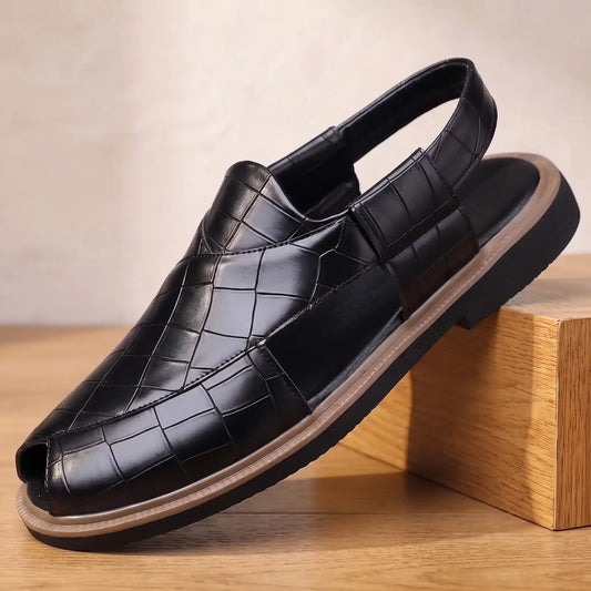 Open Back Sandals in black, a peep toe slingback sandal in croc embossed leather with a side cut out, on an oak display block