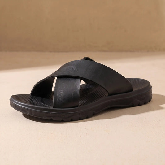 Black men's cross-strap slide sandal on sandy floor