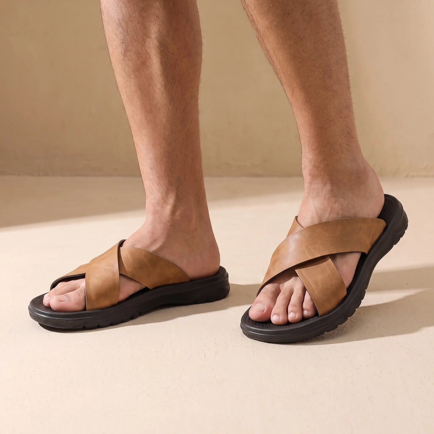 Man wearing the pair of camel slide sandals