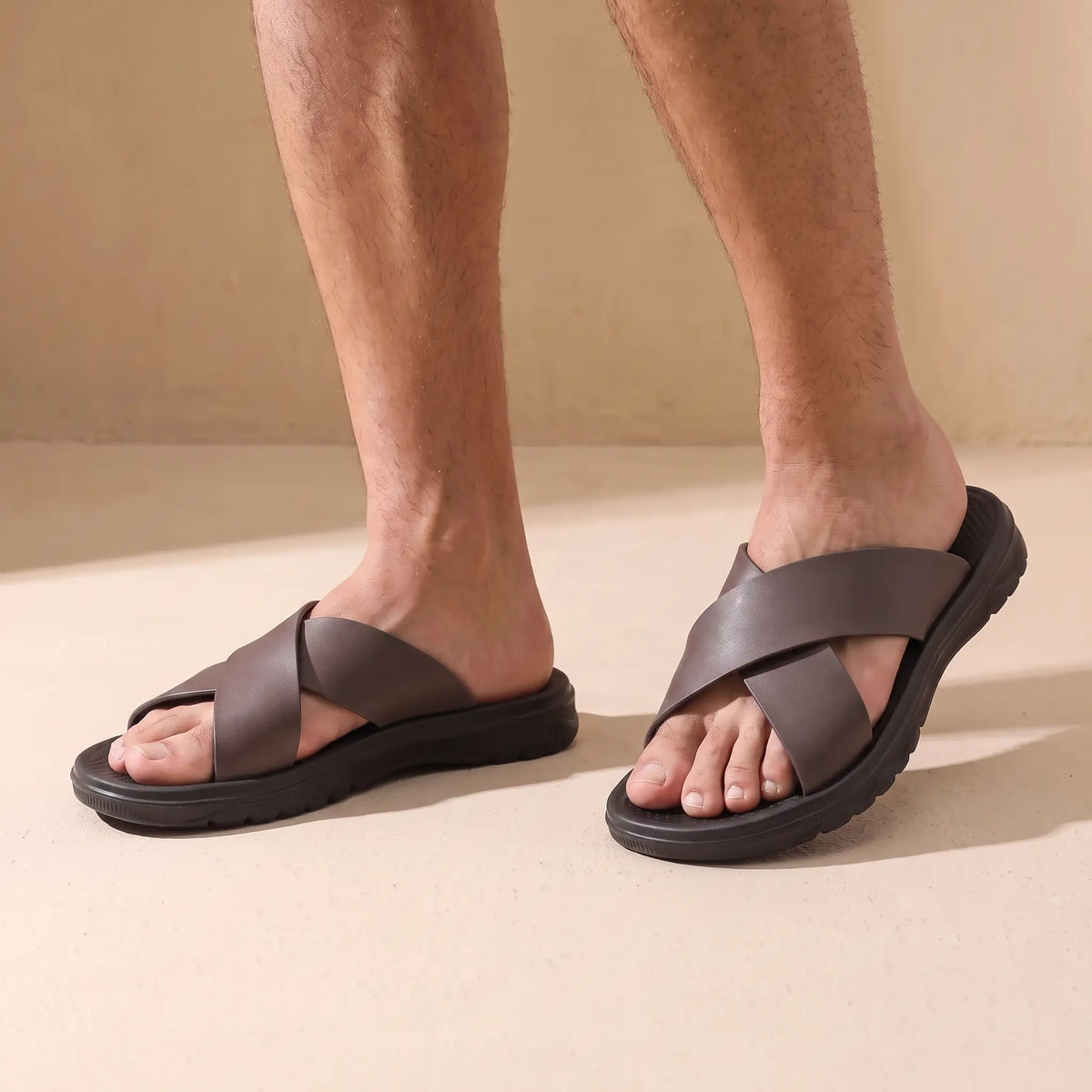 Man wearing the pair of red brown slide sandals