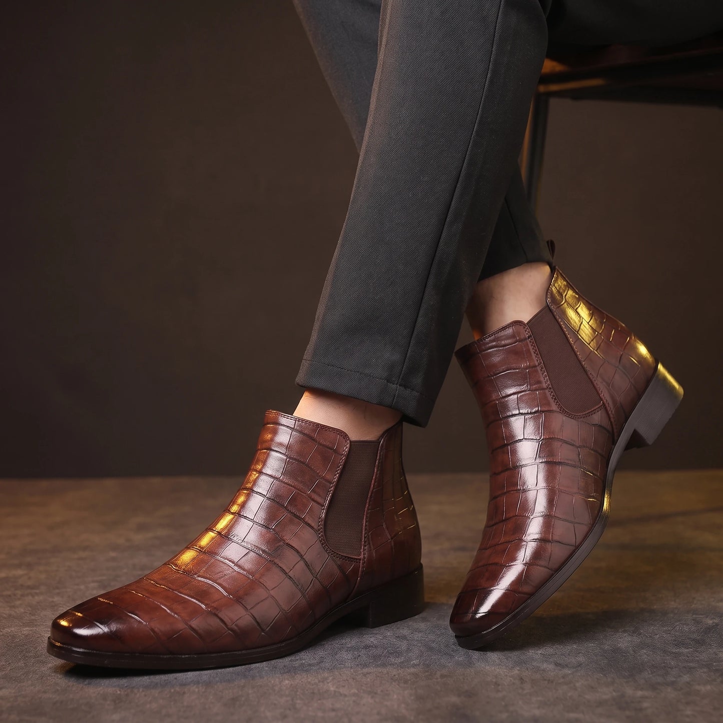 CROC GRAIN BOOTS worn by a man in dark trousers, crossed-ankles view