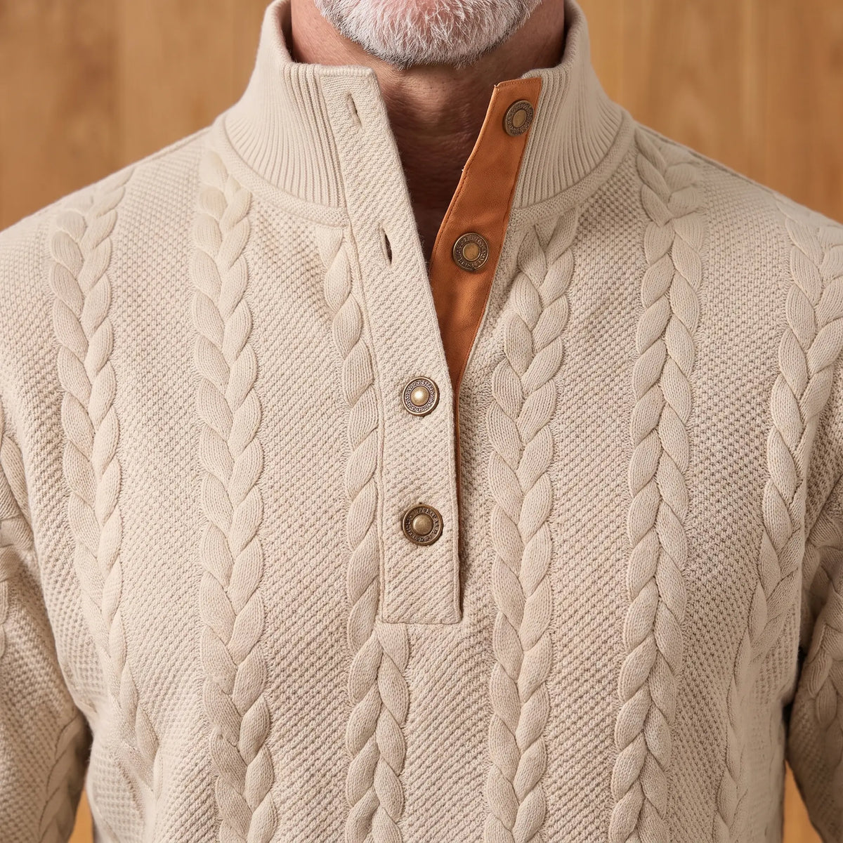 Close-up of the ribbed stand collar, three-button placket and tan facing on the khaki cable knit henley