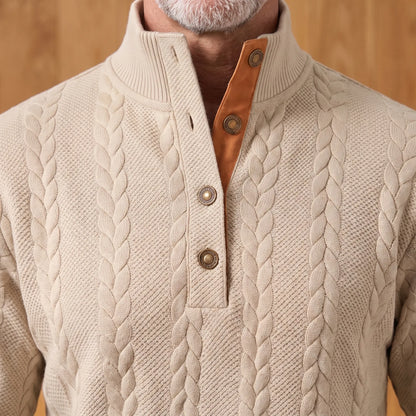 Close-up of the ribbed stand collar, three-button placket and tan facing on the khaki cable knit henley