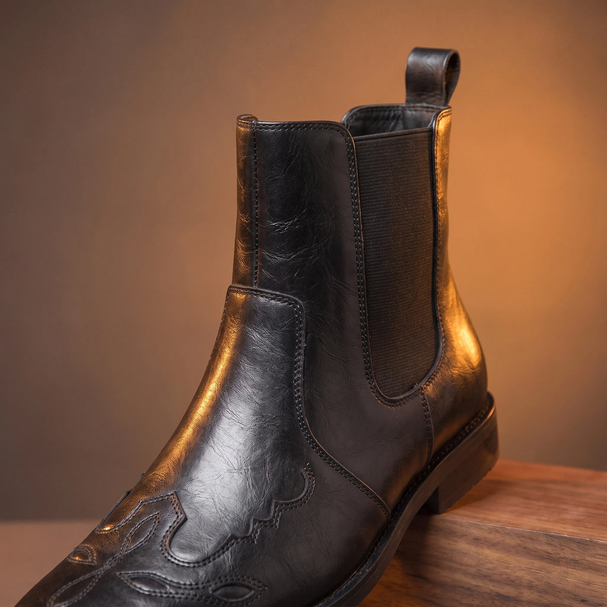 Close-up of black leather boot pointed toe and gore