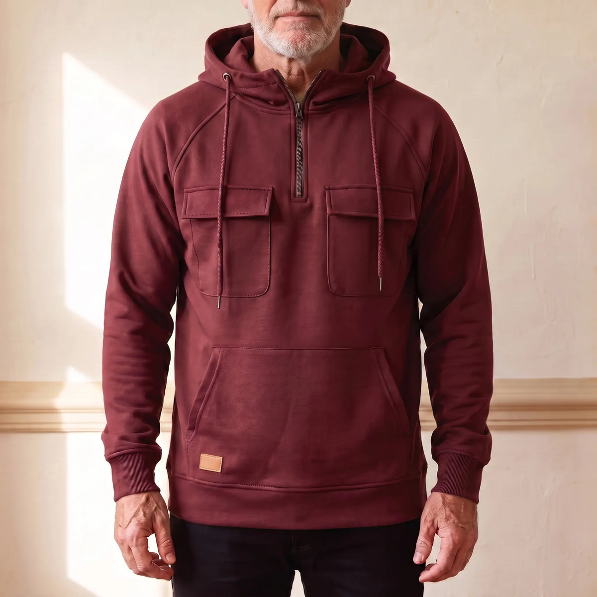 Men's deep red hooded anorak sweatshirt with half zip and twin chest flap pockets, worn