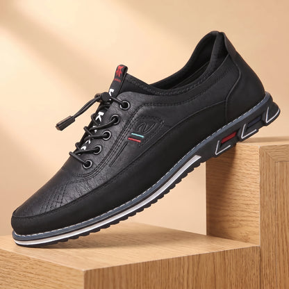 SMART CASUAL SNEAKERS black casual leather sneaker on a light oak platform, warm daylight