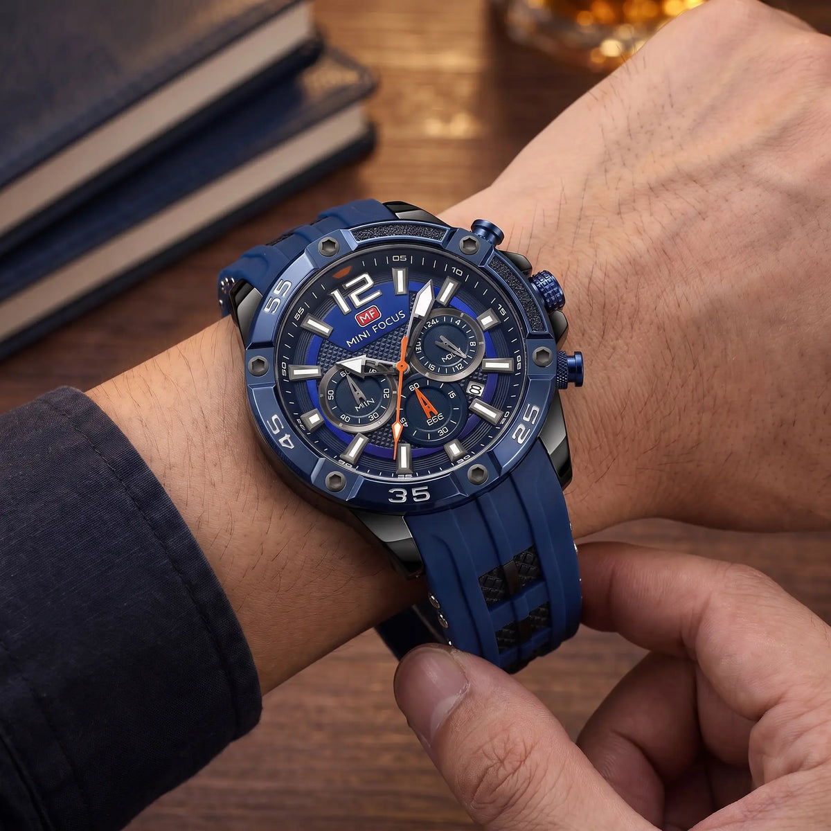 Man fastening the blue screw bezel chronograph watch onto his wrist