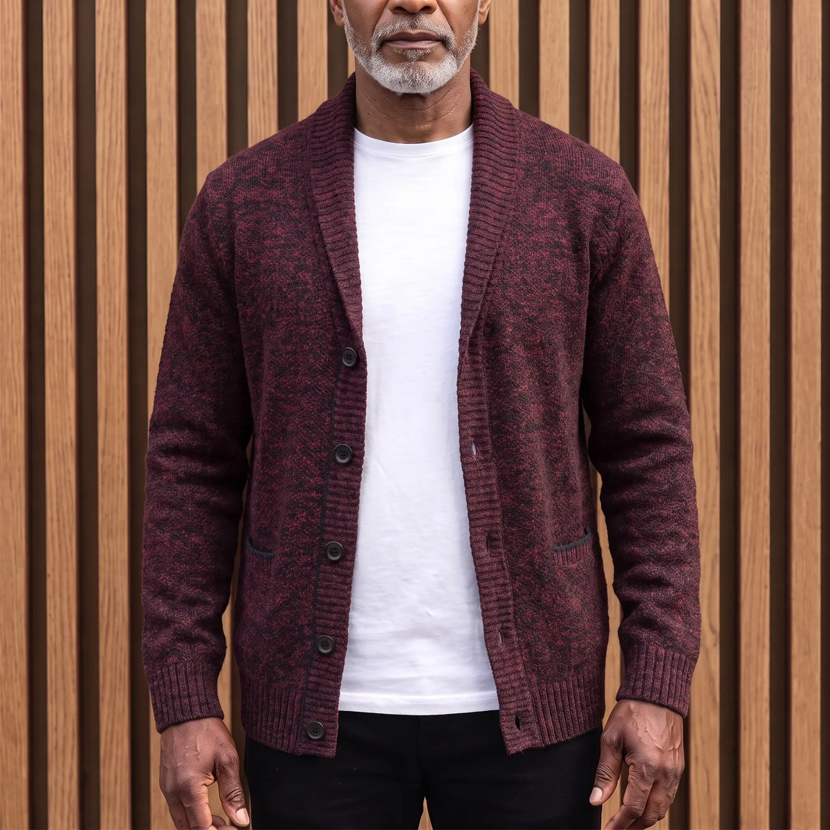 Men's deep red flecked knit shawl collar cardigan worn open over a white tee