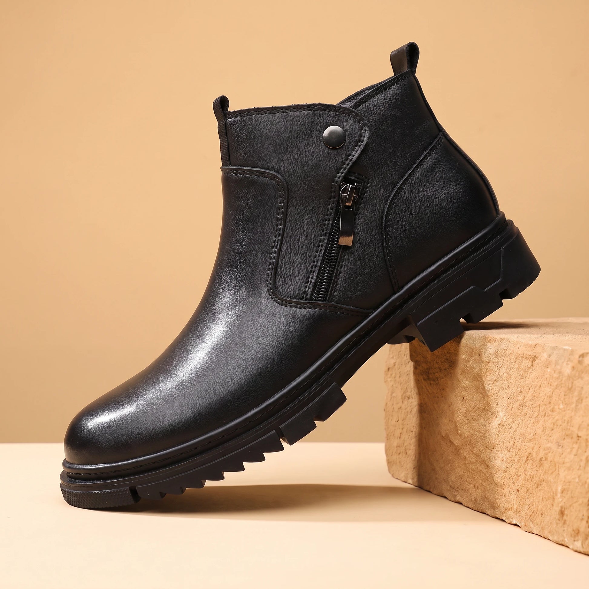SHARP ZIP ANKLE BOOTS black leather high-top side-zip boot on a warm sandstone block