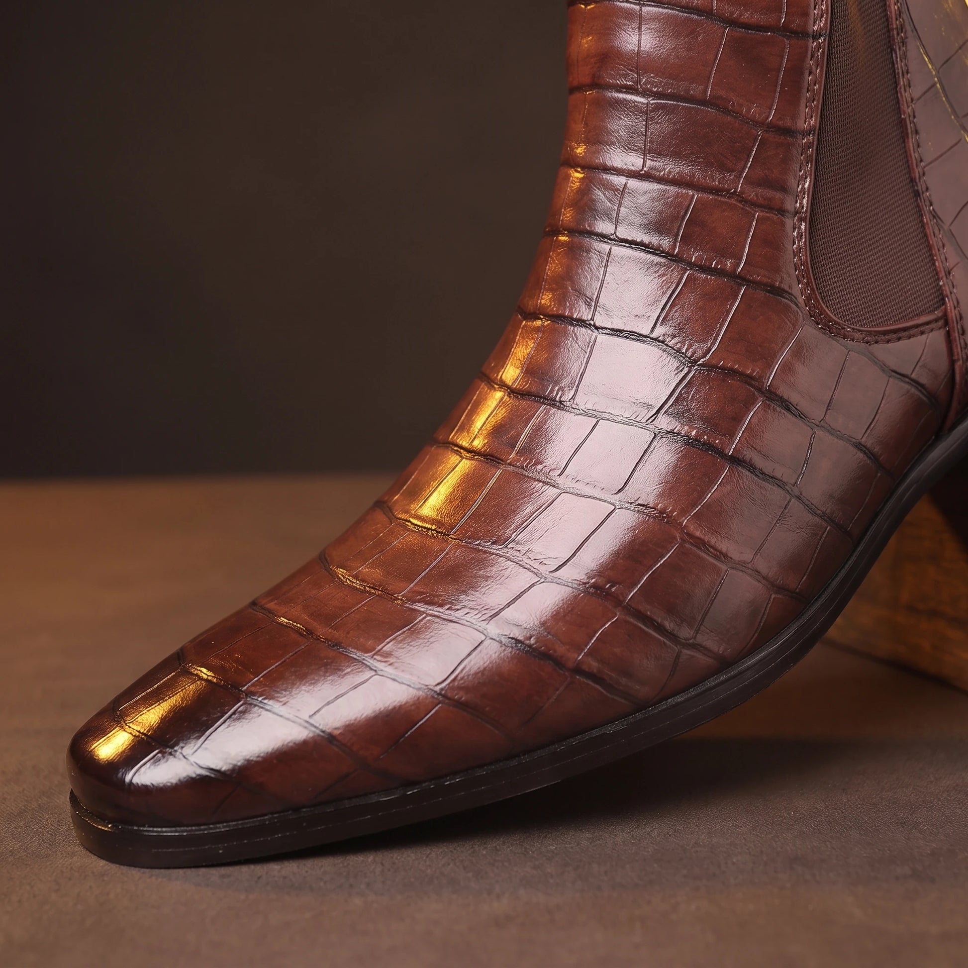 CROC GRAIN BOOTS close-up detail of the pointed toe and croc grain texture