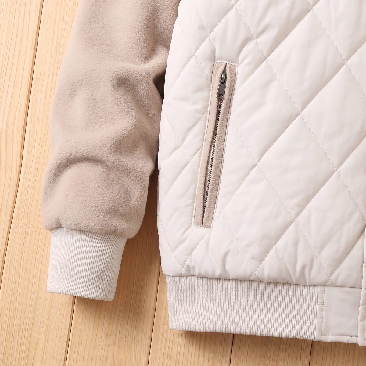 Ribbed cuff, hem band and zip pocket detail
