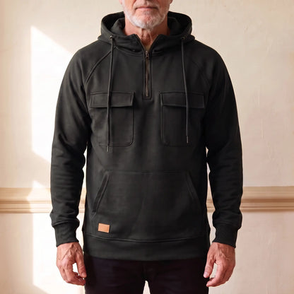 Men's black hooded anorak sweatshirt with half zip and twin chest flap pockets, worn