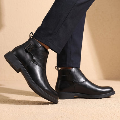 Man wearing black leather Chelsea boots mid-stride