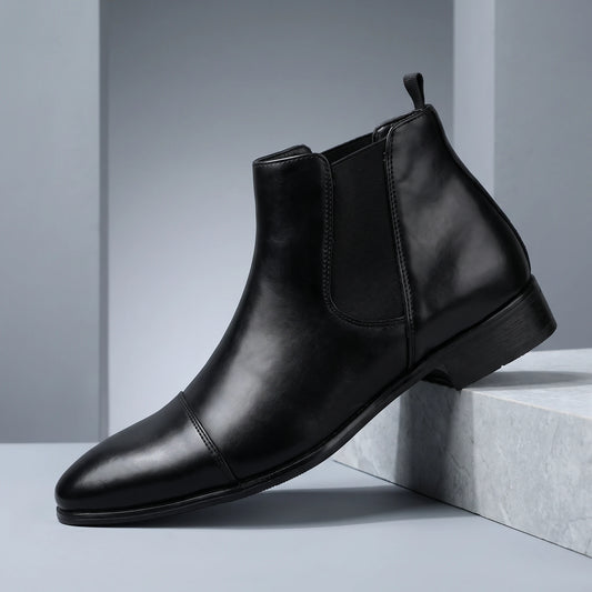 SMOOTH GENTLEMAN BOOTS black Chelsea boot on a grey stone plinth in a cool grey studio