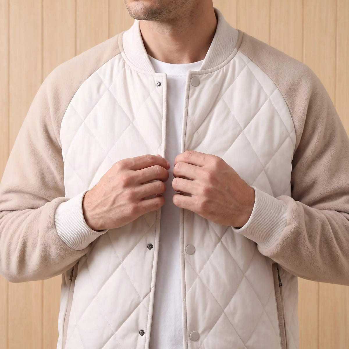Man fastening the quilted varsity jacket