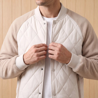 Man fastening the quilted varsity jacket