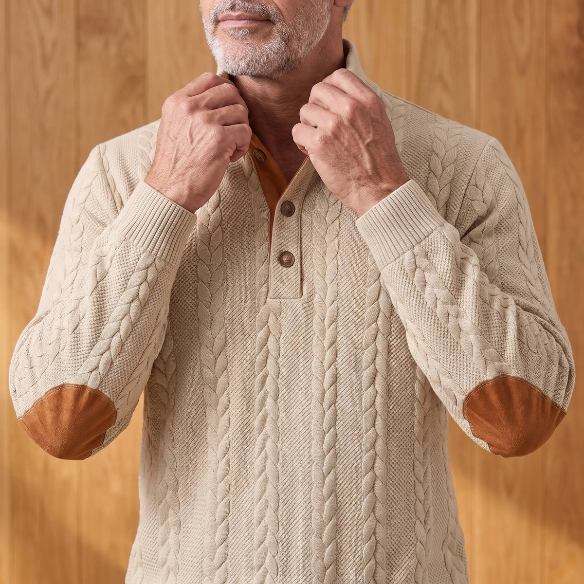 Man turning up the stand collar on the khaki cable knit henley sweater