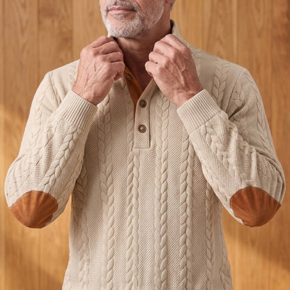 Man turning up the stand collar on the khaki cable knit henley sweater
