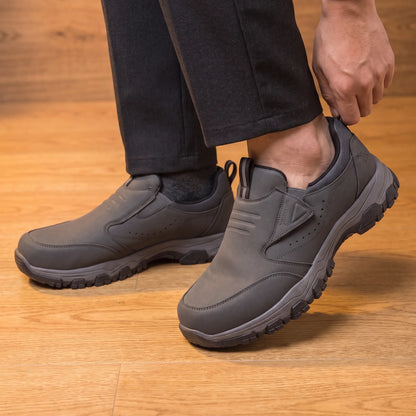 Man stepping into the grey slip-on loafers