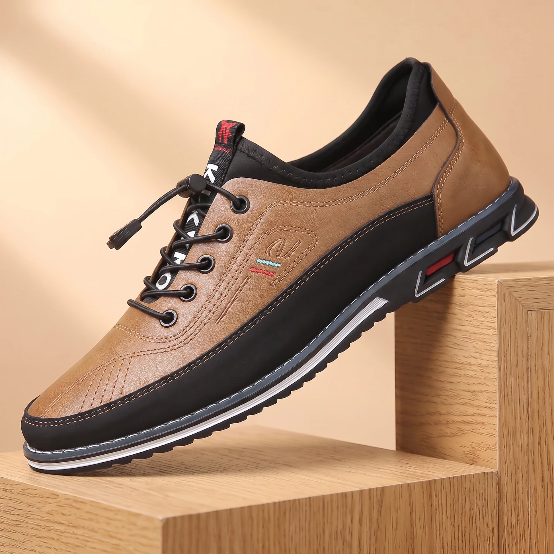 SMART CASUAL SNEAKERS beige-tan casual leather sneaker on a light oak platform, warm daylight